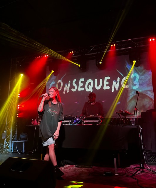 photo of singer with consequence band on stage